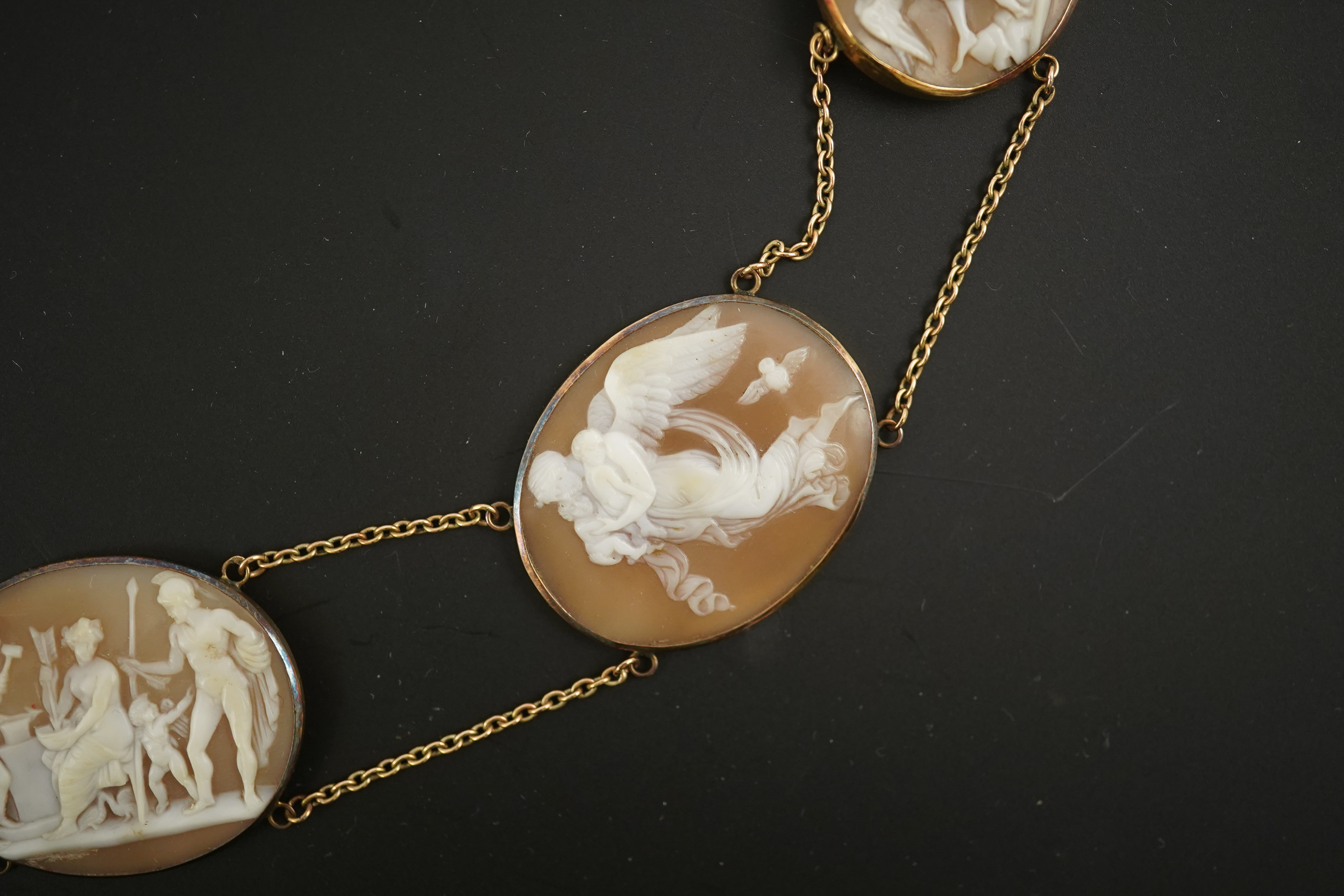 An early 19th century Italian Grand Tour gold double chain link and ten graduated oval cameo shell set necklace